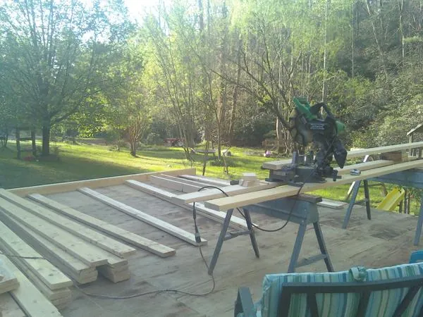Miter saw and framing lumber on a deck under construction in Fond Du Lac
